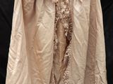 un manteau beige orné de dentelle sur fond noir