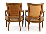 two wooden chairs with upholstered arms and arms with a beige upholstered seat