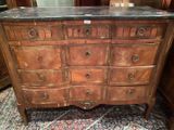 une commode en bois avec un plateau en marbre dans une chambre