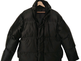 a black jacket on a hanger on a white background