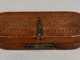 an old wooden box with a metal latch on it