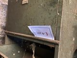 an old metal filing cabinet with a sign on it