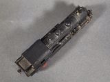 a small toy train on a table with a gray background