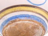a white bowl with a blue and yellow design on it