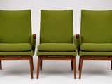 a pair of green chairs sitting next to each other on a white surface