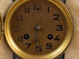 two clocks that are on the wall of a building