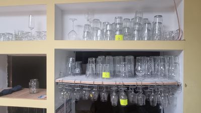 many empty glasses on the shelves in the kitchen