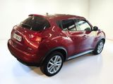 a picture of a red nissan suv in a showroom