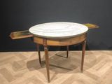 an image of a table with a marble top sitting on top of a hard wood floor