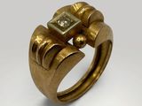a close up of a gold ring with a square stone in it