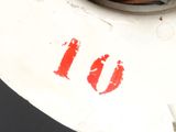 a close up of a toilet with a red number on it