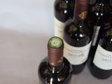 several bottles of wine are lined up on a table