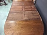 a wooden table with a curved top in the middle of a room