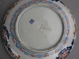 three plates with designs on them are sitting on a table