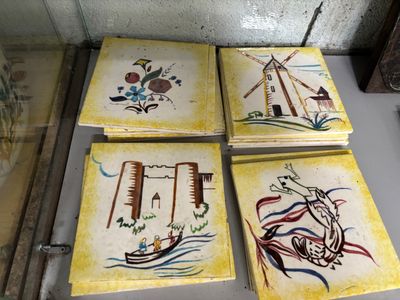 several pieces of art are on display in a glass case