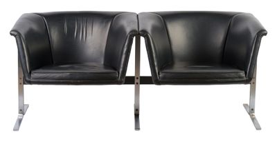 pair of black leather chairs with chrome legs on a white background