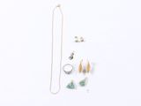 an assortment of jewelry including a necklace, earrings, and a ring