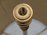 a close up of a lamp shade with a metal pole on it