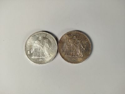 two coins that are sitting next to each other on a table