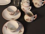 a lot of dishes and cups on the table