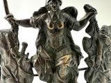 a statue of a woman holding a knife and a sword