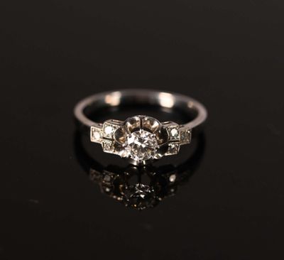 a close up of a diamond ring on a black surface