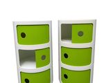 two white and green drawers with black dots on them