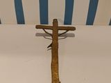 a wooden cross on a white table with a blue and white striped background