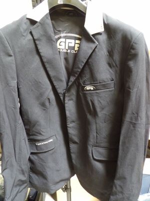 a black jacket hanging on a hanger in a store