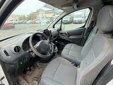 the interior of a car with the door open and the driver ' s seat down