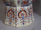 a close up of a vase on a white surface