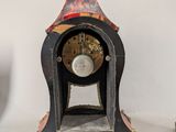 a clock that is sitting on a table next to another clock