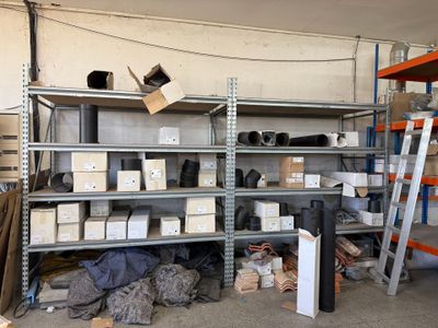 many shelves with boxes and boxes on them in a garage