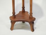 a small wooden table with a marble top on a white background