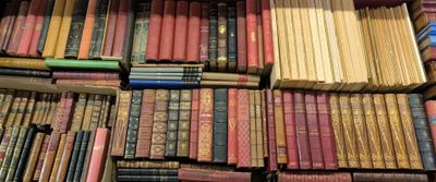 many books stacked on top of each other on a table
