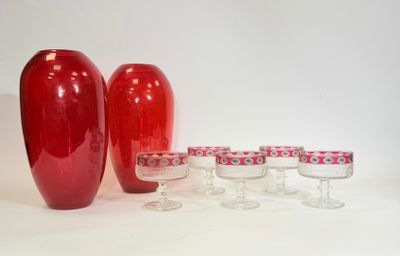 three red vases sitting next to each other on a table