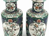 pair of chinese vases with birds and flowers on them on a white background