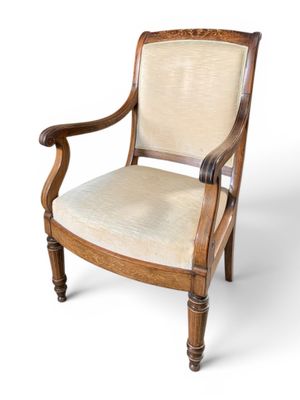 an image of a wooden chair with a beige upholstered seat