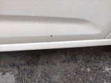 a close up of a white car with a hole in the door