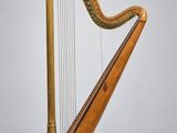 une grande harpe en bois posée sur une surface blanche