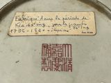 a plate with writing on it and a piece of paper on the plate