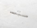 an antique silver plate with the name robert linvellek engraved on it