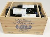 bottles of wine are in a wooden box on a table