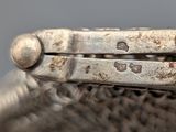 a close up of a pair of pliers on top of an ostrich ' s head