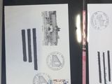 two envelopes with stamps on them sitting on a table