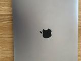 an apple laptop sitting on top of a wooden table