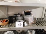 a lot of dishes on the shelves in the kitchen