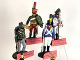 five figurines of soldiers on display in a display case