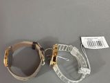 pair of clear goggles sitting on top of a table next to a tag