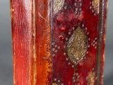 a close up of a book with a red cover on a table